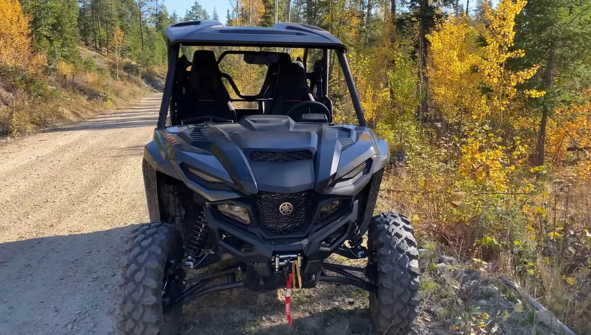 A Yamaha Wolverine RMAX 1000 is parked on jungle road.