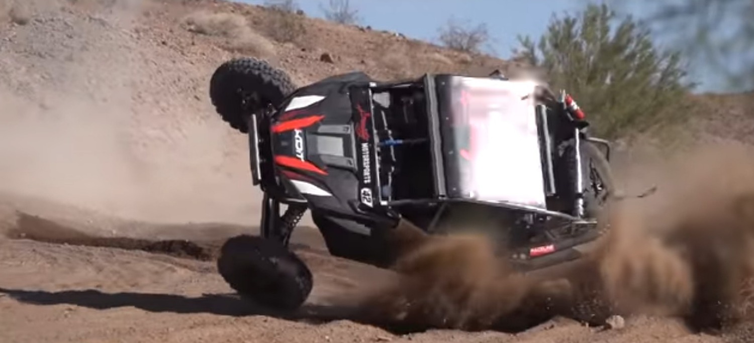 UTV rollover in desert field.