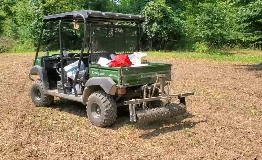 I revved up my UTV, ready to explore the wilderness, armed with a seed spreader to create a vibrant food plot for local wildlife.