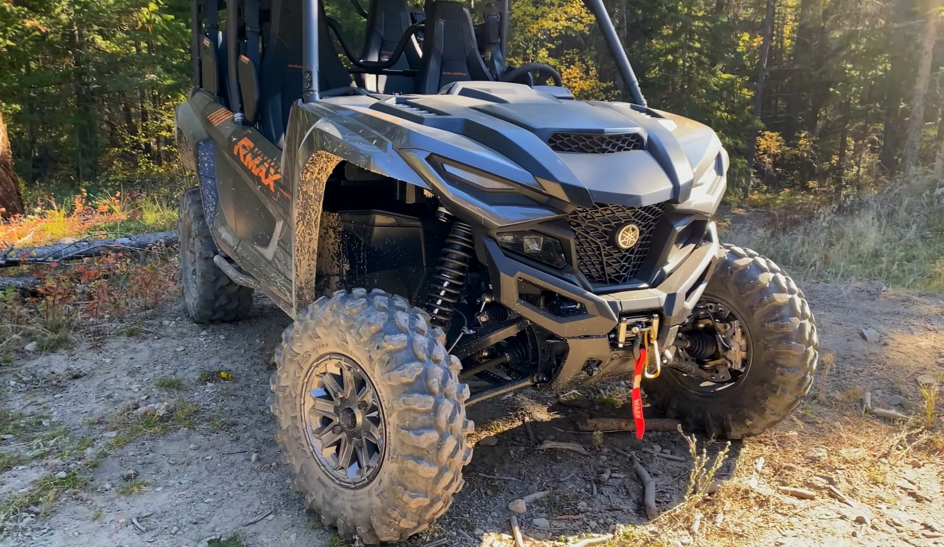 A Yamaha Wolverine RMAX4 1000 is parked in front of a deep Jungle.