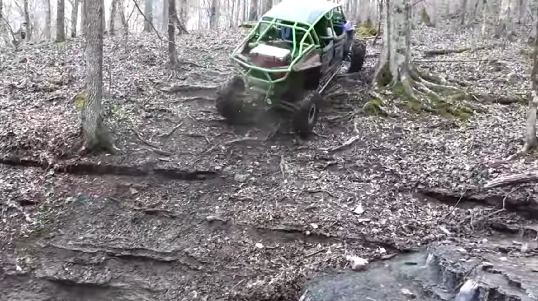 A UTV is climbing a hill in a hill climb competition.