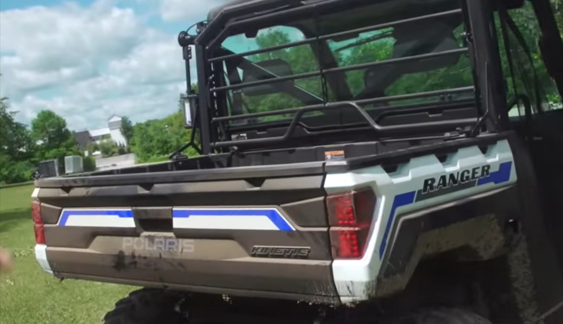 Polaris Ranger is parked on a green field.