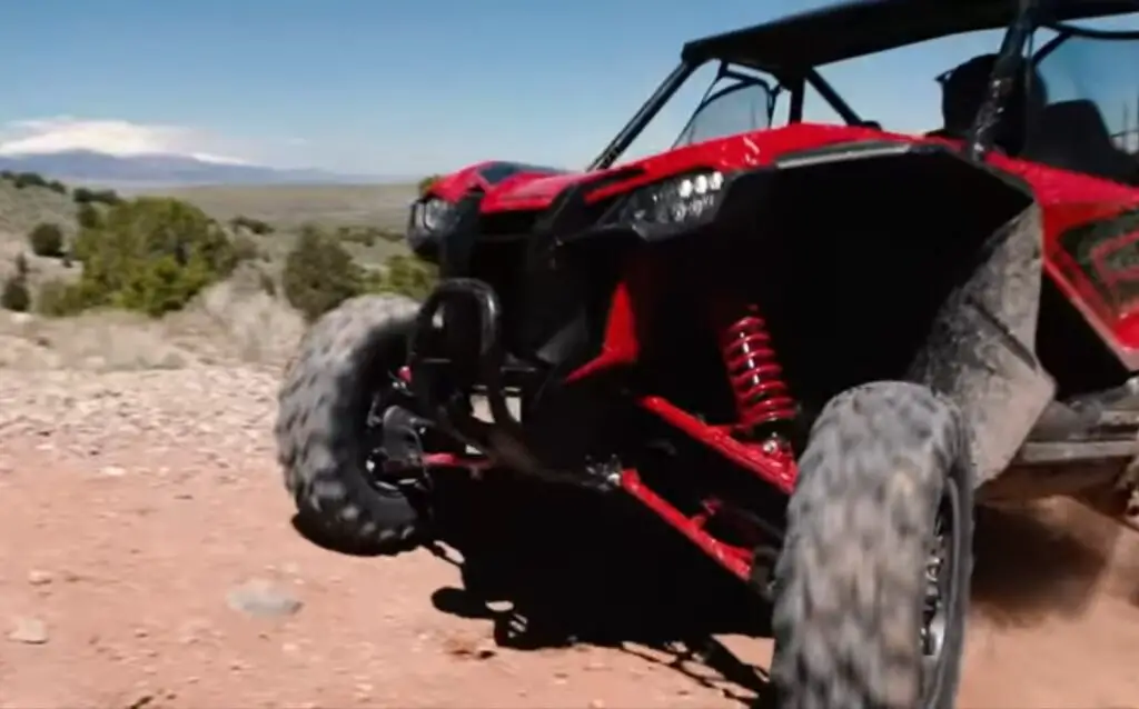 A Honda Talon UTV is parked on a dirt road.