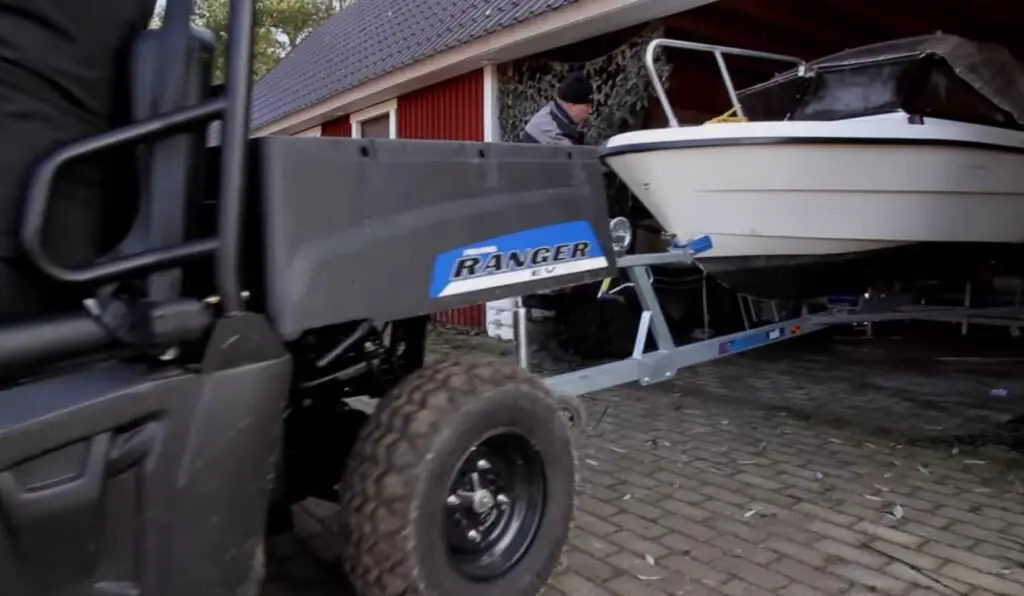 With a confident grip on the steering wheel, I guided my UTV, effortlessly towing the boat through rocky terrain.