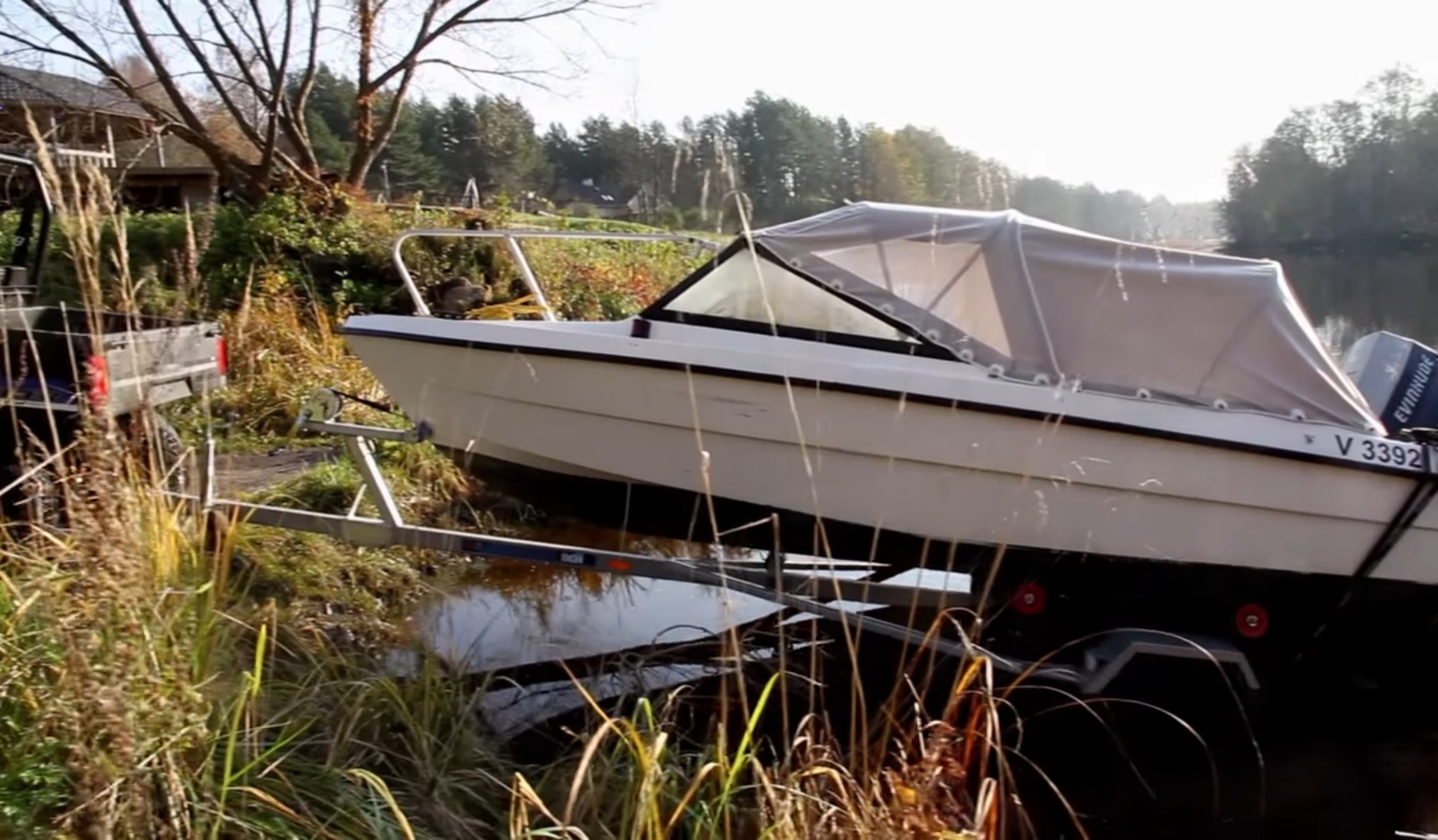 A Polaris Ranger UTV is towing a boat.