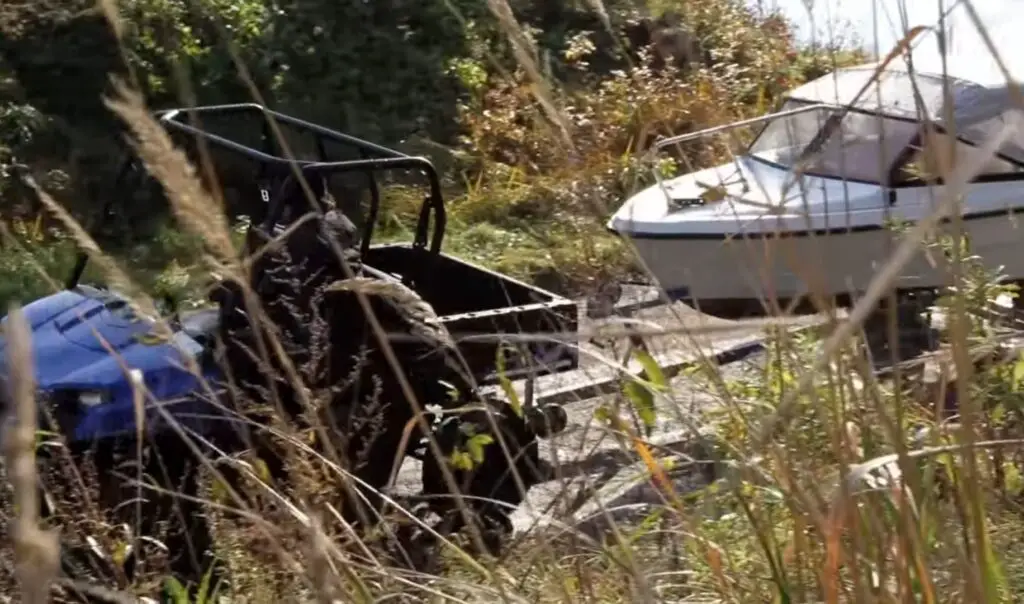 Through rough terrain and steep inclines, my UTV proves its worth as it expertly tows the boat to our desired destination.