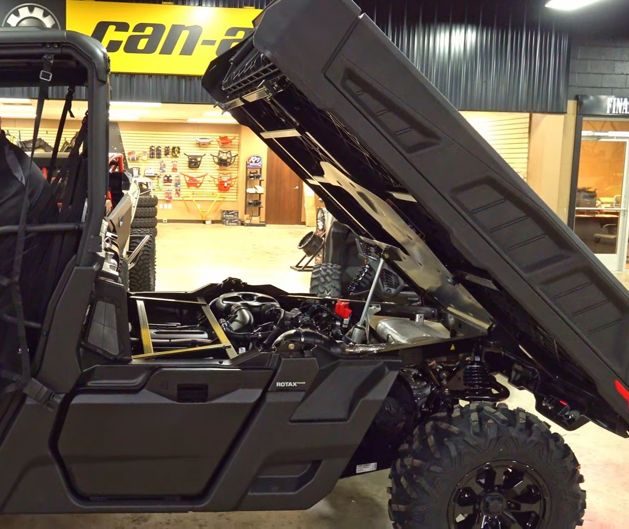 A Can-am defender pro XT is parked in a Can-am showroom.