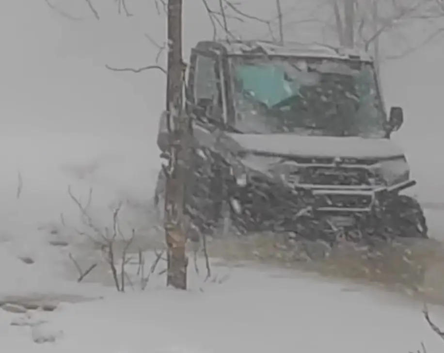 A Polaris Ranger NorthStar is being driven through a snow terrain.