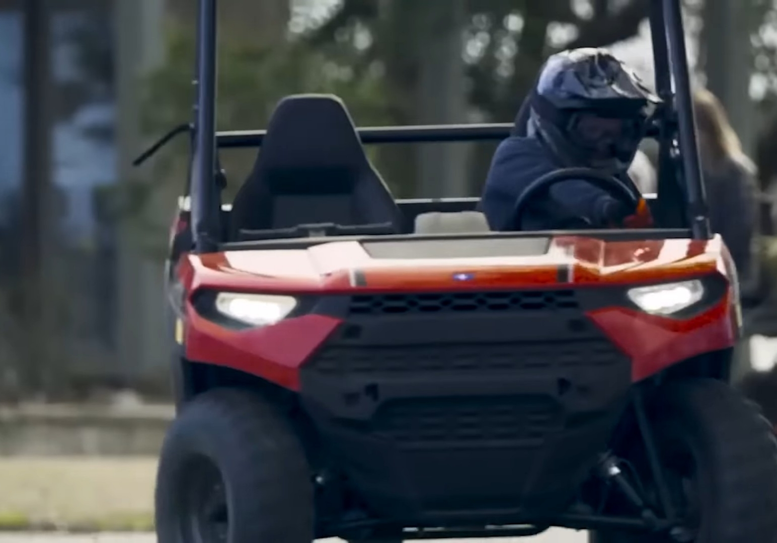 A kid is driving a child UTV.