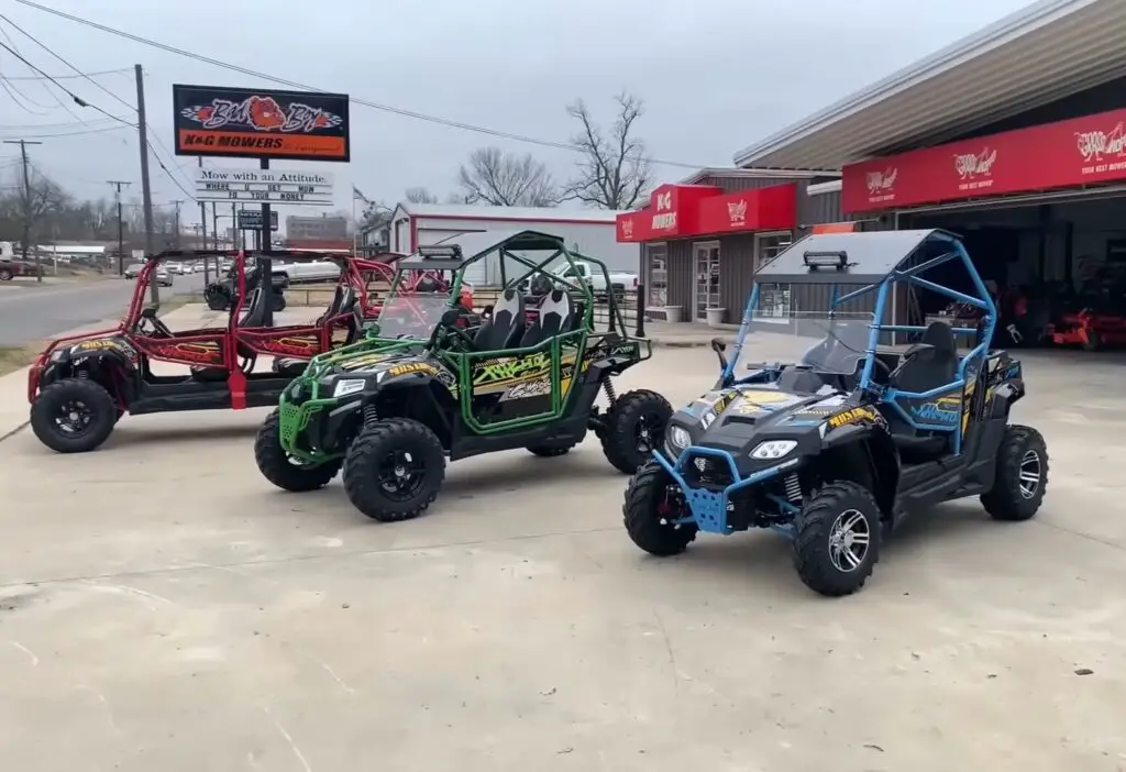 Three child UTVs are parked in front of a UTV showroom.