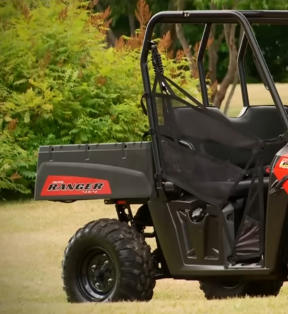 Polaris Ranger 500 is parked in a green garden.