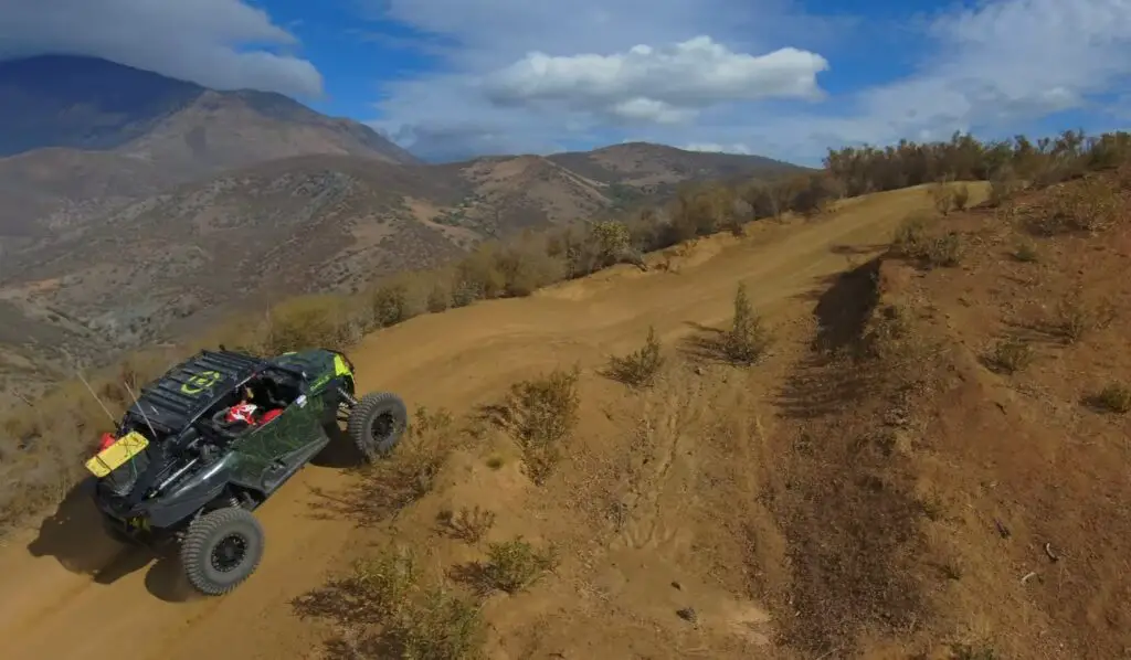 A Polaris turbo is being driven through a hill road.