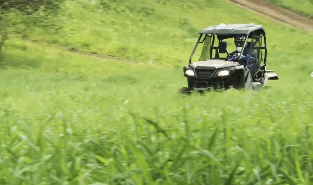 Across the open fields, I rode my Honda Pioneer 500, the freedom of the grasslands stretching out before me, a solitary figure in a vast expanse.