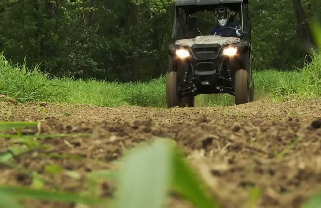 Along the dirt roads, I revved up my Honda Pioneer 500, the thrill of the unknown propelling me forward, a lone adventurer on a dusty trail.