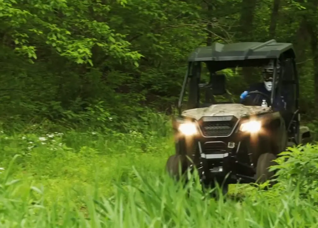 I navigated my Honda Pioneer 500 through the dense forest, the thrill of discovery driving me forward, each twist and turn a new chapter in my wild adventure.