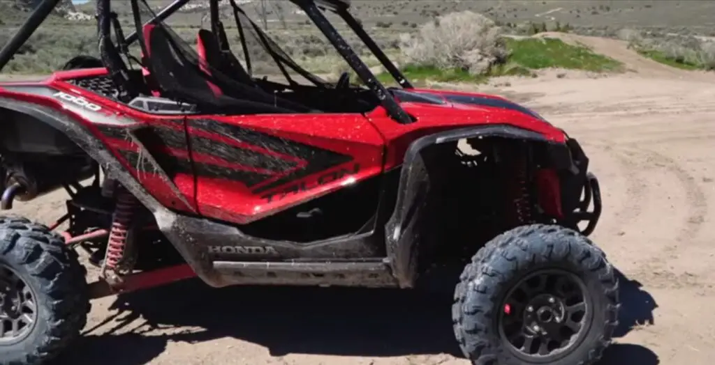 A Honda Talon 1000R is parked on a dirt surface.