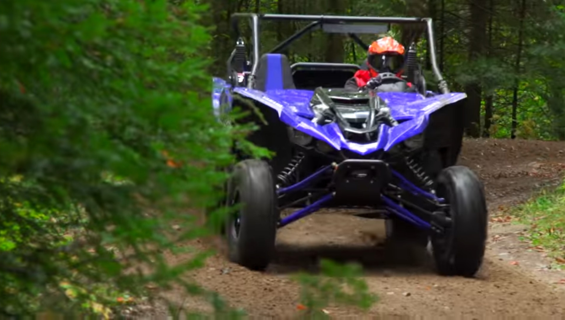 I was driving the Yamaha YXZ 1000R through a green forest.