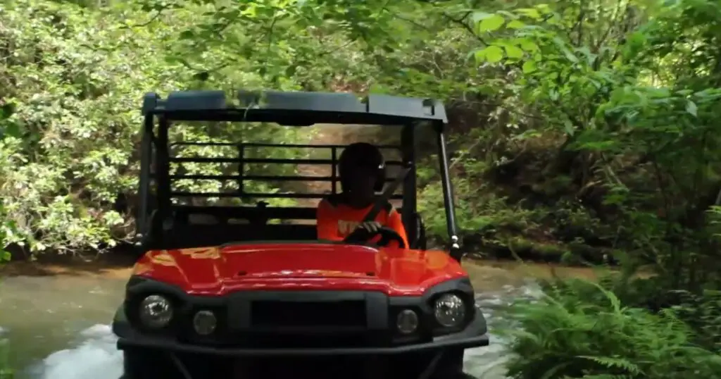 A Kawasaki Mule Pro-FX EPS LE is being driven through a deep Jungle.