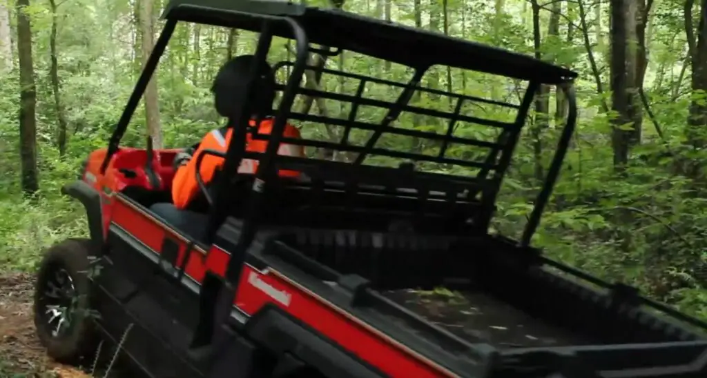 A Kawasaki Mule Pro-FX LE is being driven through a forest.