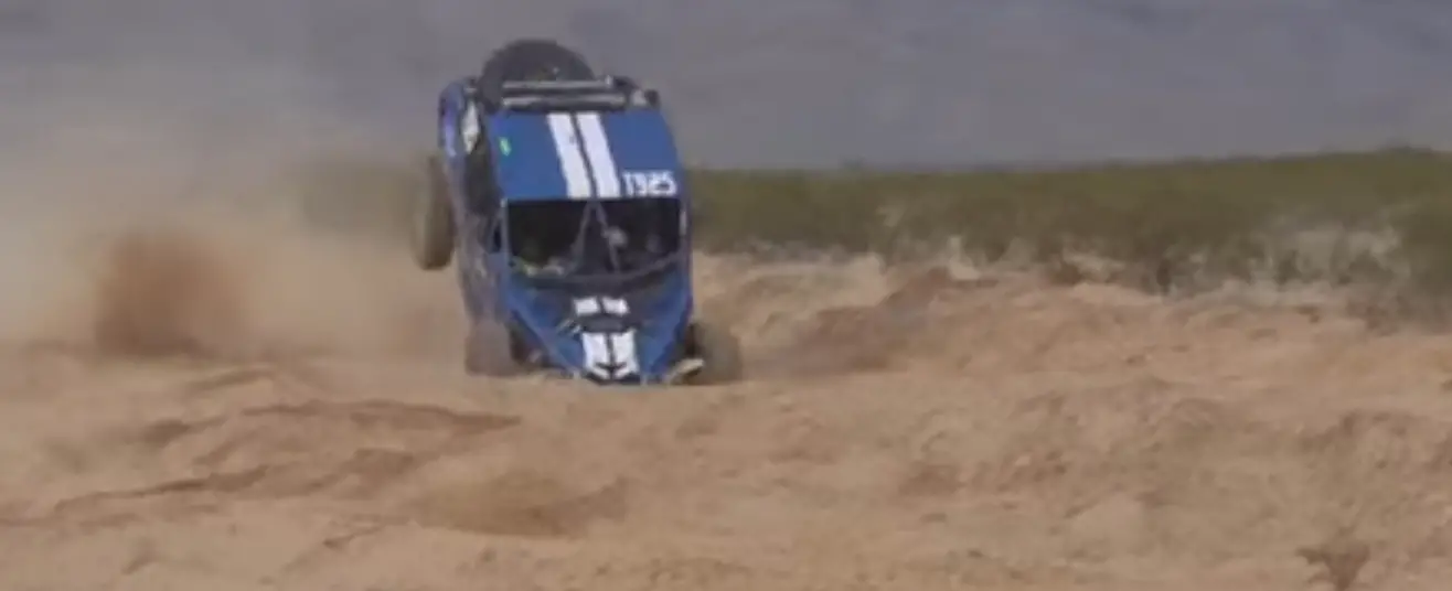 UTV accident in a sandy desert surface.