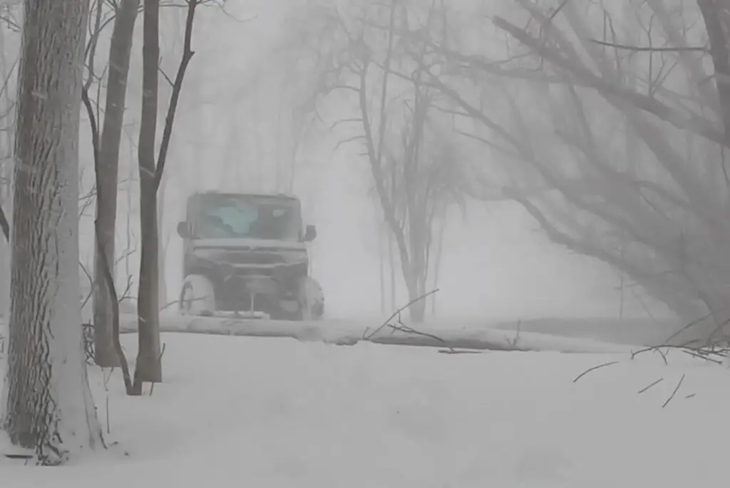 A Polaris Ranger NorthStar is being driven through a snow terrain.