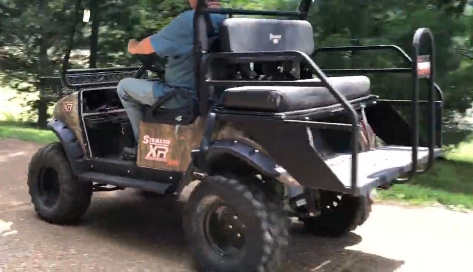 A person is riding on a Stealth Electric 4x4 UTV.