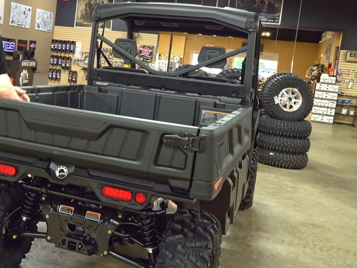 A Can-am defender pro XT is parked in a garage.