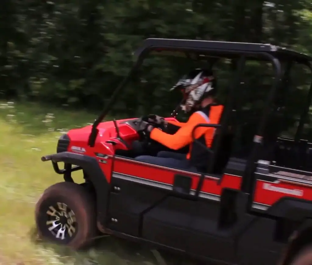 A Kawasaki mule pro FX LE is being driven through a jungle terrain.