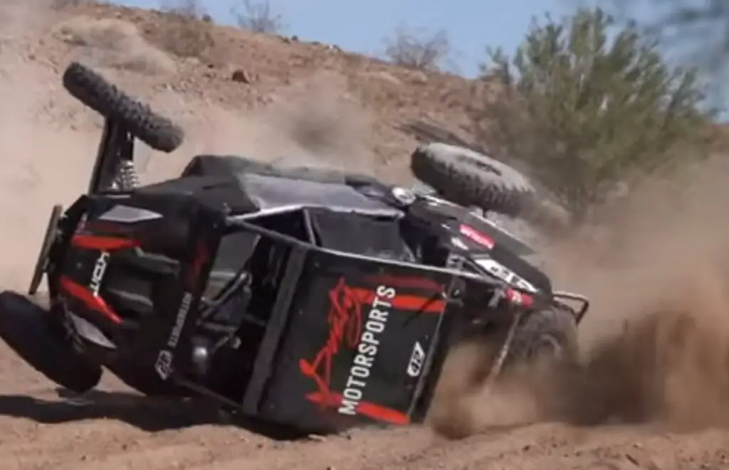 A UTV flip in a desert sandy road.