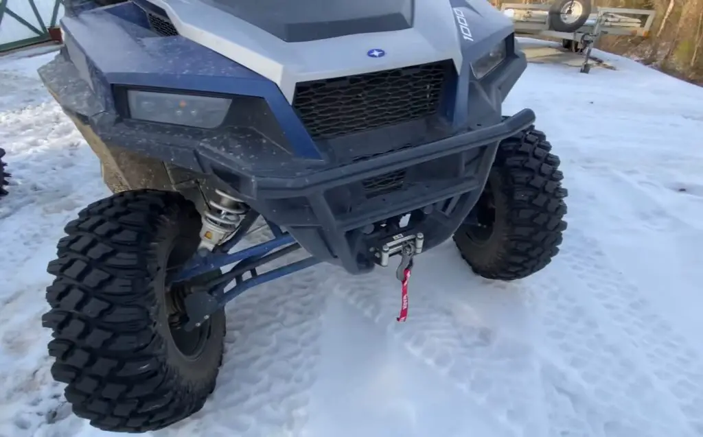 With the thermometer dipping, I lowered my UTV tire pressure to 5 PSI, bracing for a challenging ride through the snow.