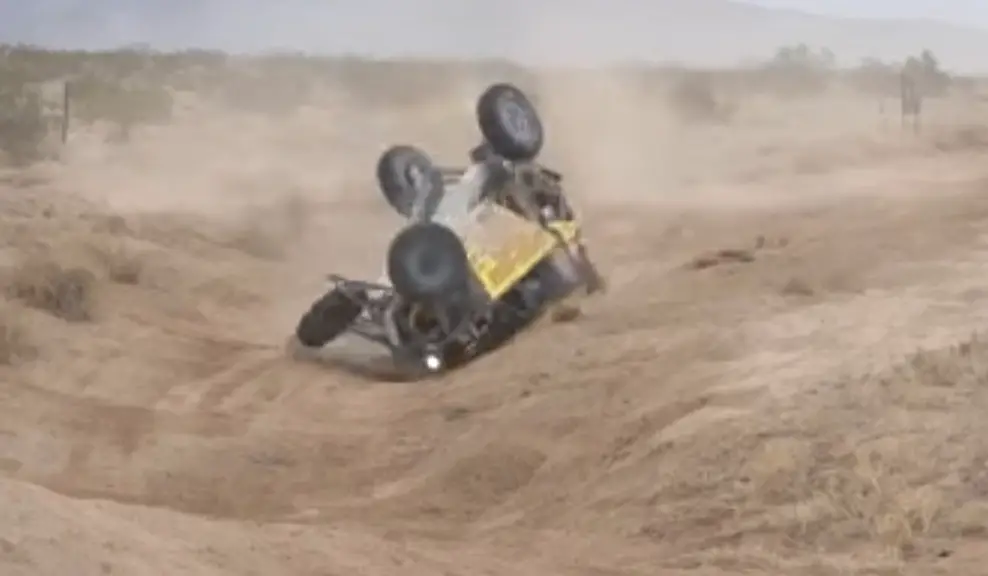 UTV rollover in desert field.