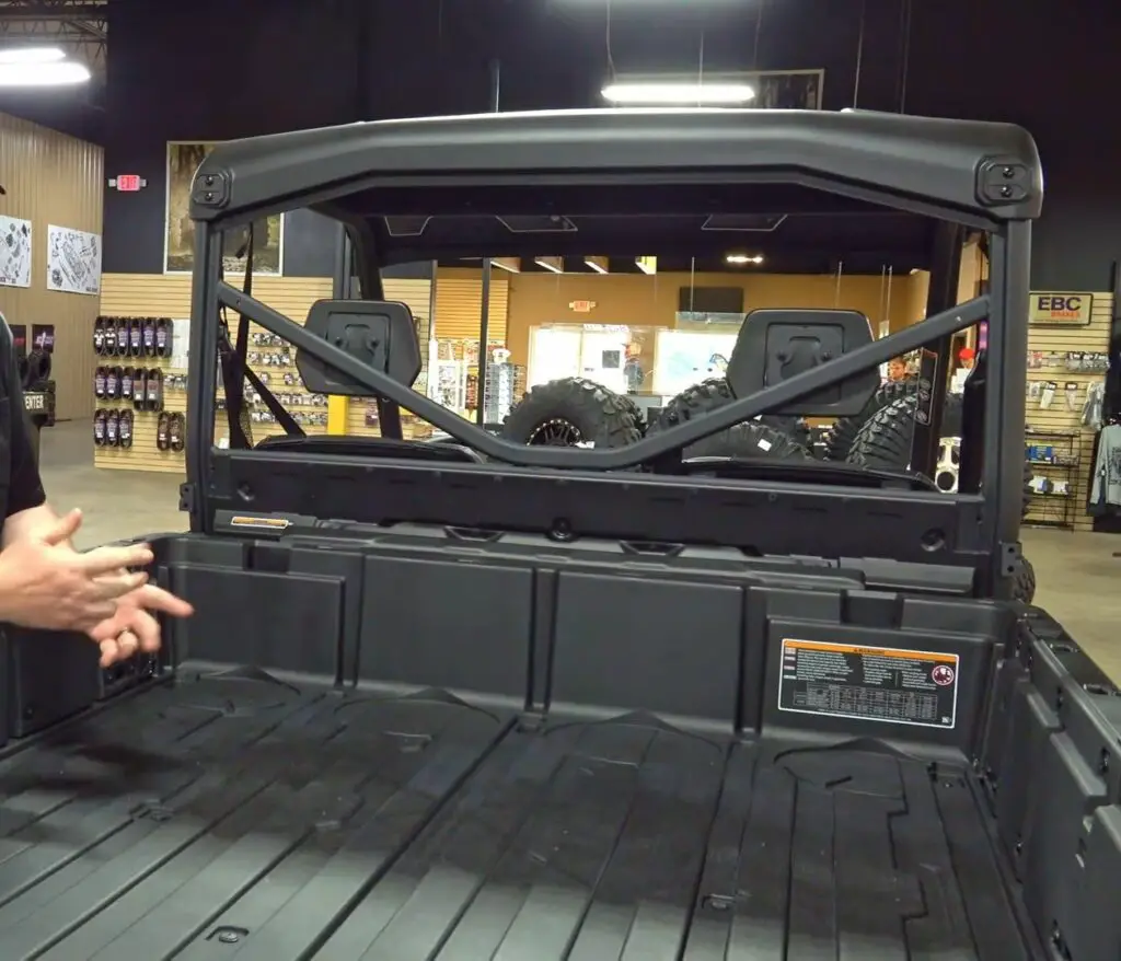 A Can-am defender pro XT is parked in a garage.