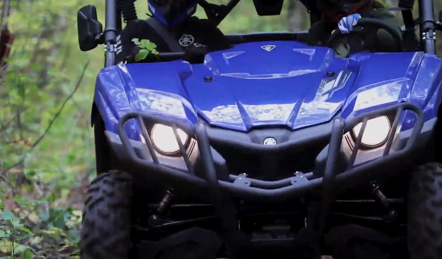 A Yamaha Viking UTV is being driven through a jungle terrain.