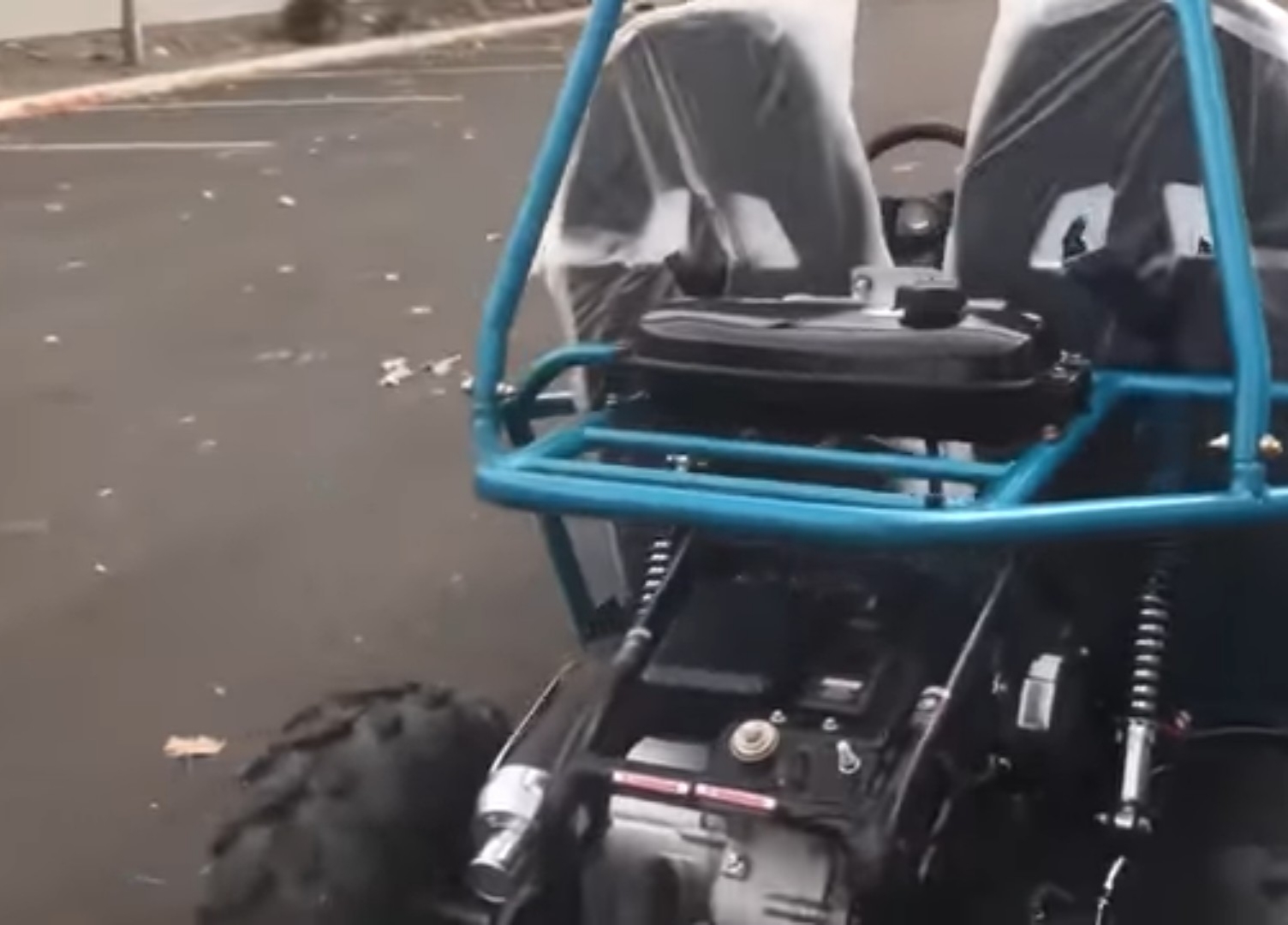 A child UTV is parked on a road.